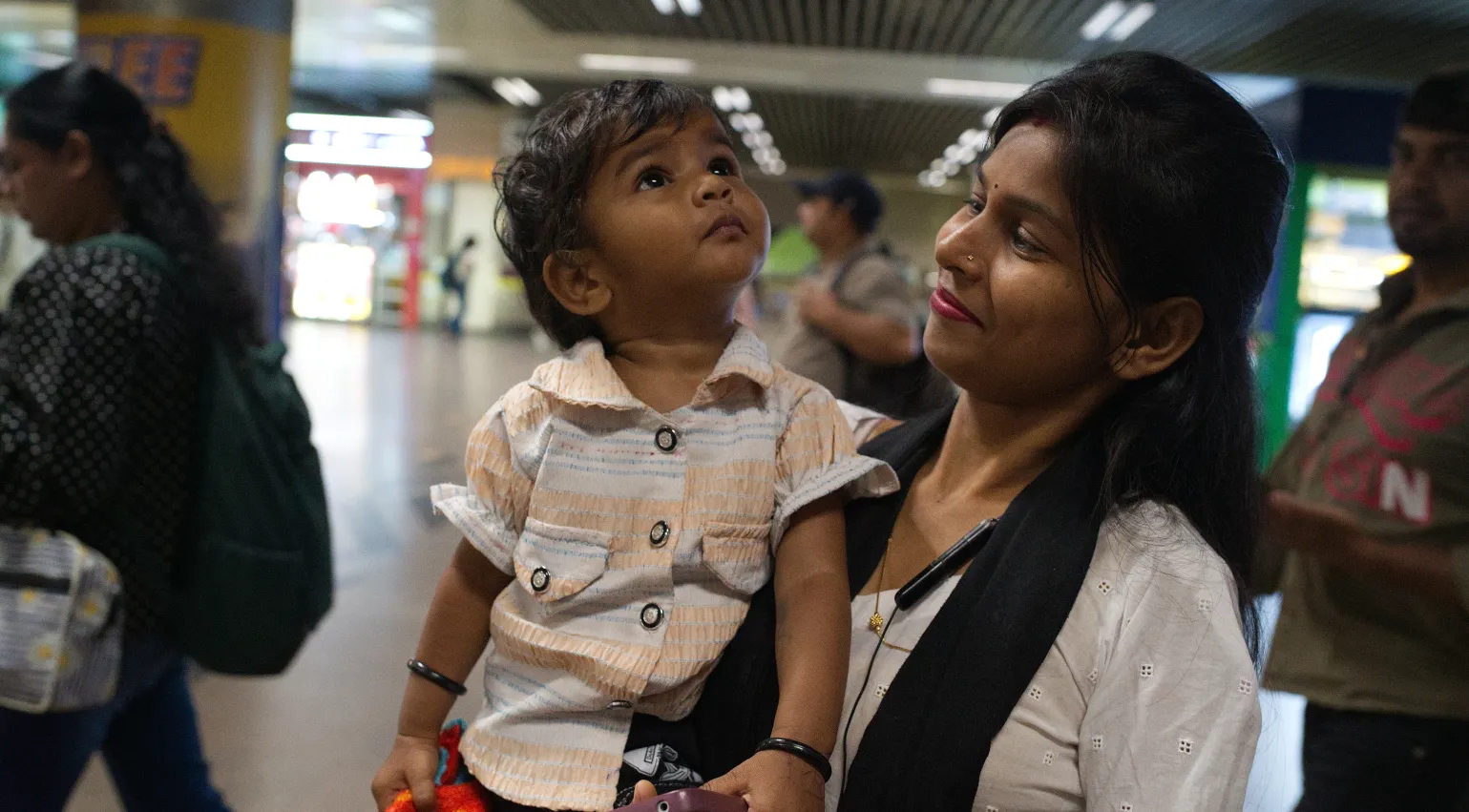 Photograph of a woman and her child using the Delhi metro