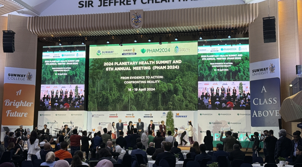 Photograph of the Planetary Health Annual Meeting with speakers on stage and conference participants