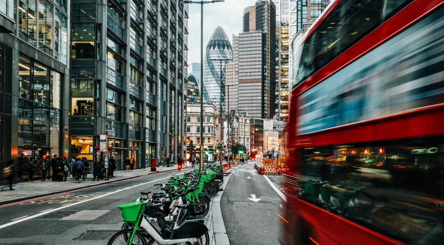 Photograph of London with bicycles, buses and buildings