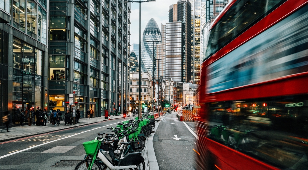 Photograph of London with bicycles, buses and buildings