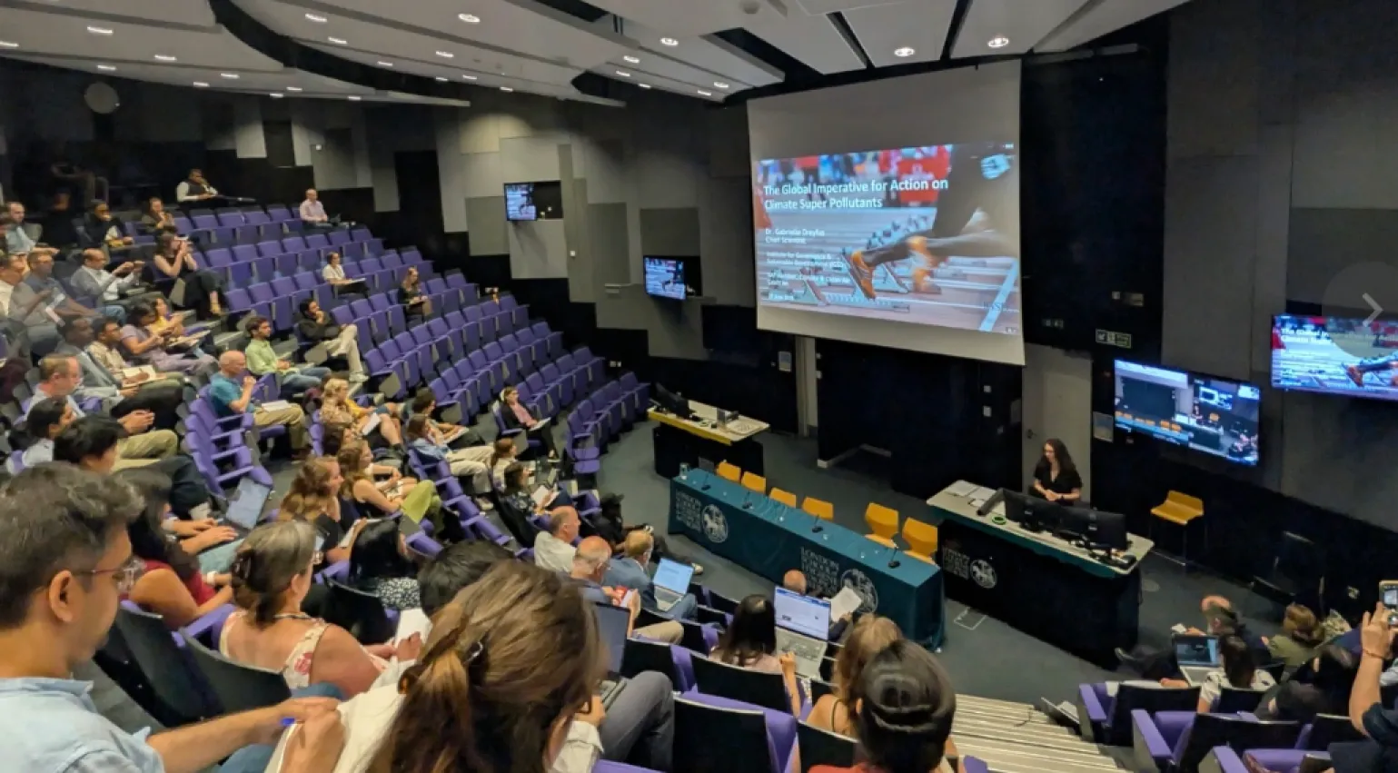 Photograph of Dr Gabrielle Dreyfus presenting at a London Climate Action Week event at the London School of Hygiene & Tropical Medicine