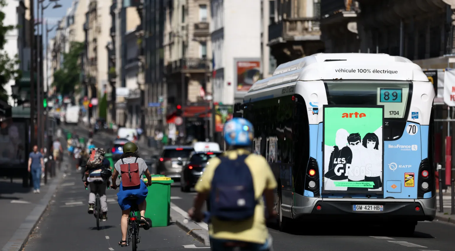Photograph of Paris street with bikes and an electric bus
